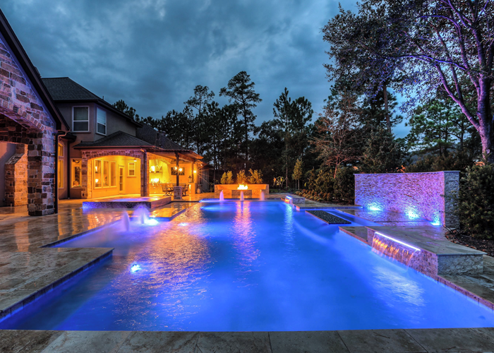 Modern pool shown with led lights displaying at night.