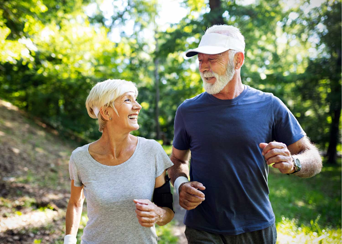 Senior man and woman going for a walk outdoors.
